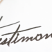 Elegant handwritten 'Testimonial' heading with reading glasses, representing client satisfaction at Jayne's Luxury Rentals