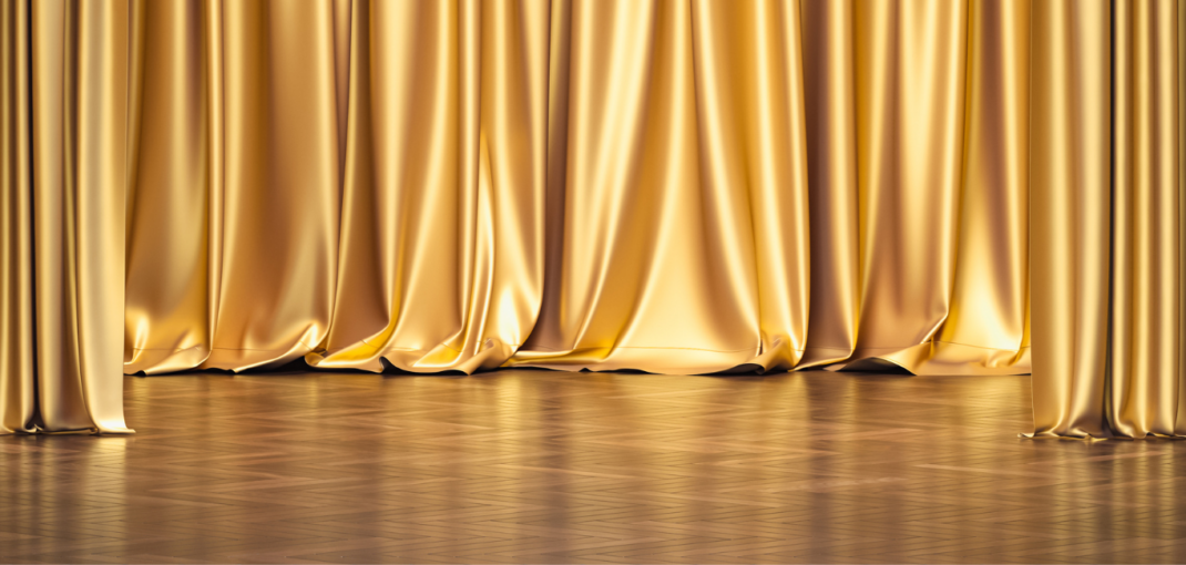 Elegant gold curtains on stage, symbolizing the prestigious RBC Canadian Women Entrepreneur Award nomination for Jayne's Luxury Rentals