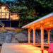 Twilight view of Bella Muskoka cottage with illuminated interiors and waterside gazebo in Port Carling, Ontario - featured in 6 Hot New 2019 Cottages blog - Jayne's Luxury Rentals