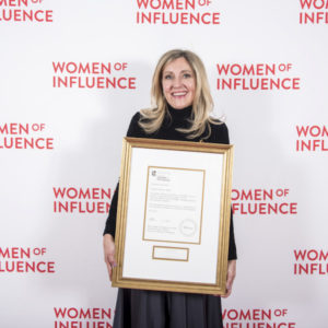 Owner of Jayne's Luxury Rentals proudly holding the 2019 Canadian Women Entrepreneur Award, a testament to her visionary leadership and innovation