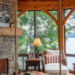 Primrose Property in Huntsville - Jayne's Luxurious Rentals | Cozy lakeside living room with stone fireplace and panoramic views