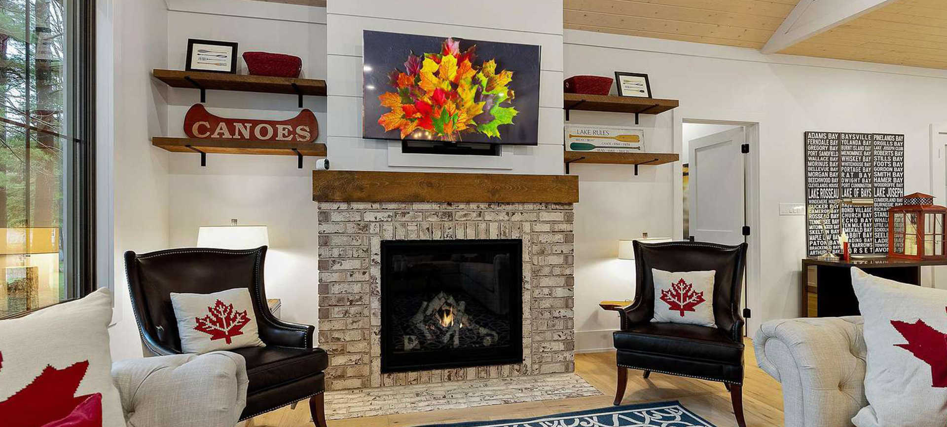 Cozy cottage living room with a warm fireplace and Canadian-themed decor, illustrating Jayne's Luxury Rentals' blog on fresh decorating tips