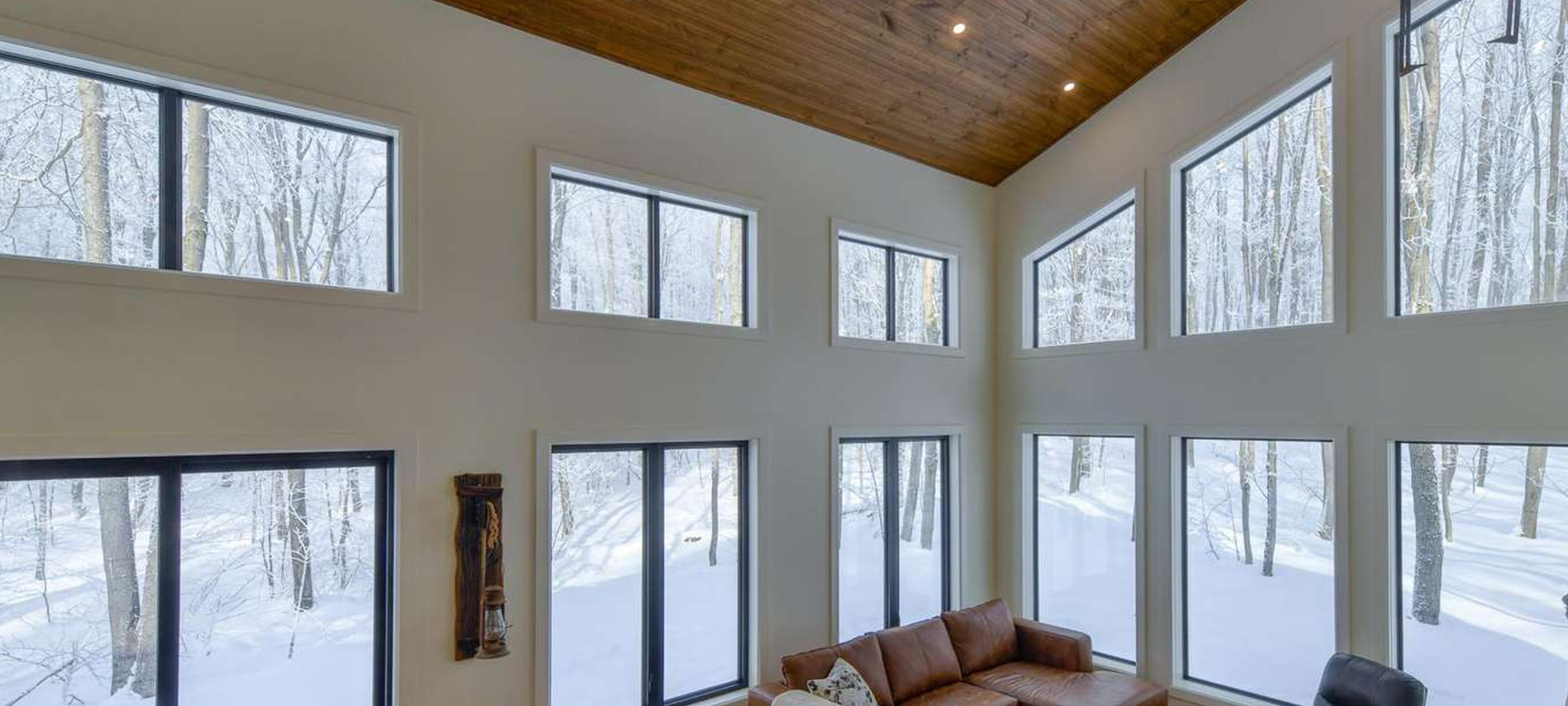 Mystical Bluff Cozy cottage interior with expansive windows revealing a snowy landscape, symbolizing winter preparedness by Jayne's Luxury Rentals