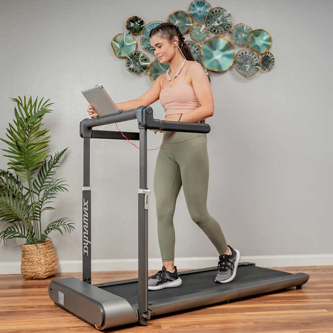 Guest enjoying fitness amenities with smartwatch in the well-equipped home gym at Jayne's Luxurious Rentals."