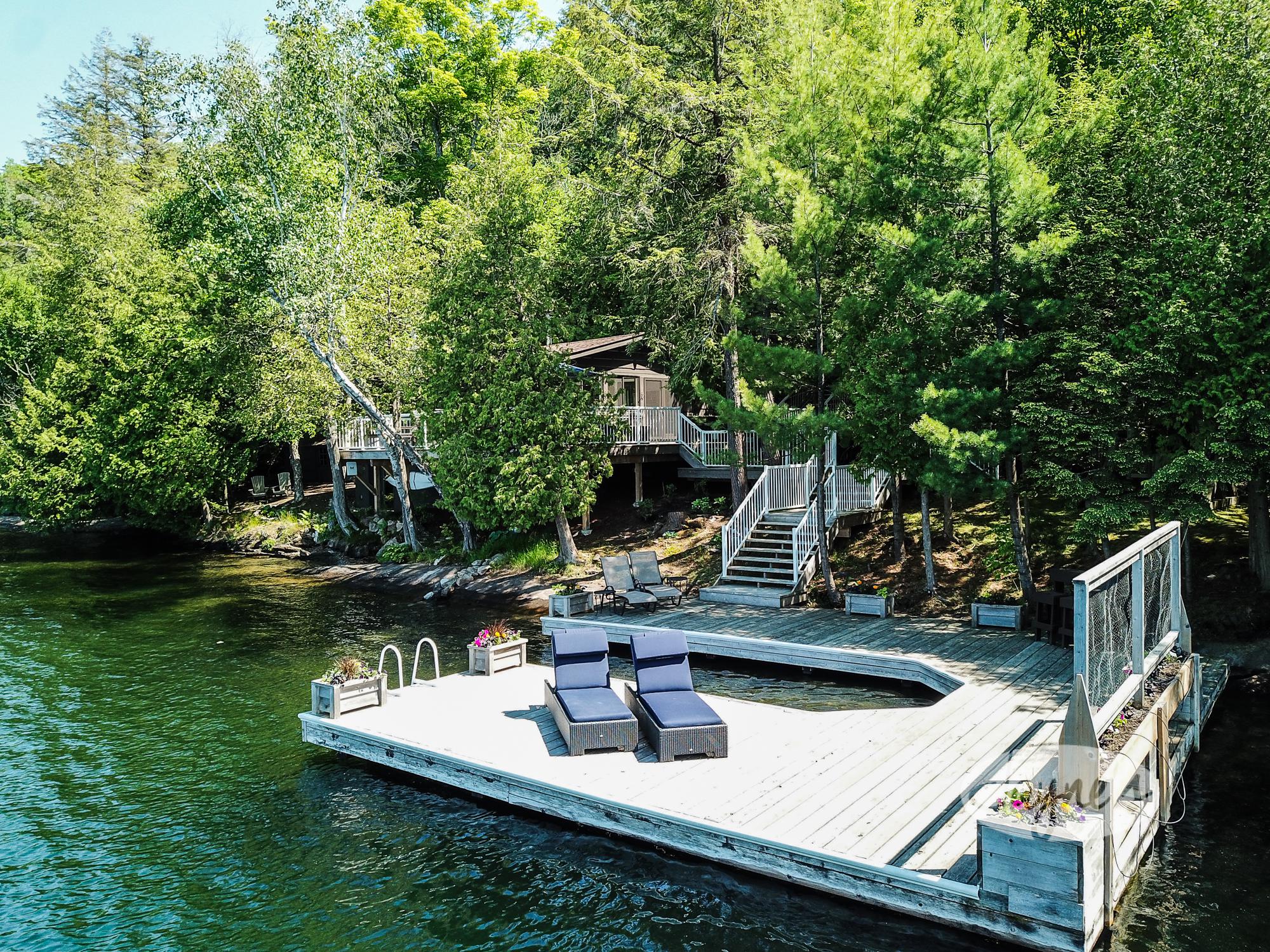 Lakeside Dream Property on Lake Rosseau - Jayne's Luxurious Rentals | Secluded cabin retreat with private dock and lounge chairs