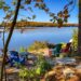 Panoramic Point - serene lake view with colorful Adirondack chairs - Jayne's Luxurious Rentals | Calm waters and autumn foliage