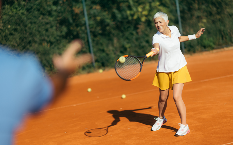 Energetic guest enjoys a personalized tennis lesson at Jayne's Luxury Rentals.
