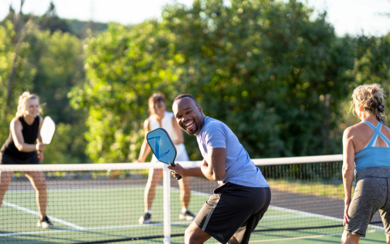 Guests enjoy a spirited game of pickleball, one of the many group activities available at Jayne's Luxury Rentals.