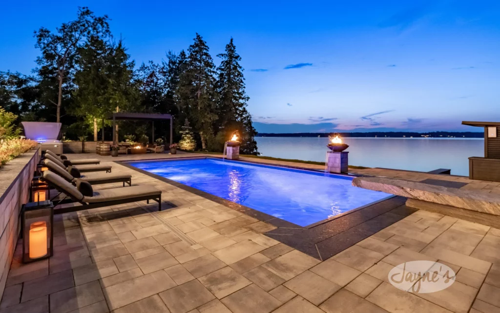 Serene twilight by the pool at Chateau Lake Simcoe with tranquil water views, curated by Jayne's Luxury Rentals.