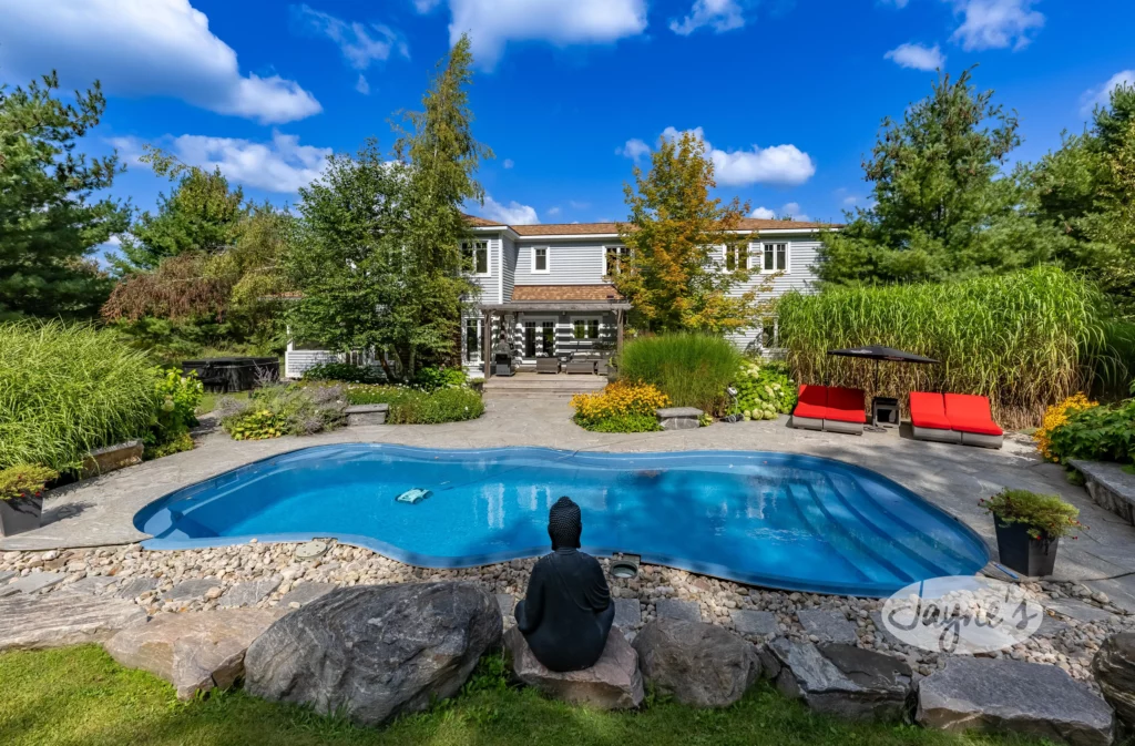 Private natural stone pool with a rustic backdrop at Lake and Pool Paradise near Lake Muskoka, presented by Jayne's Luxury Rentals.