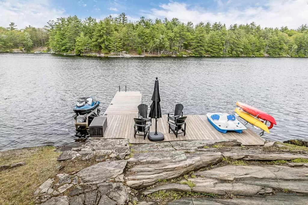 Lakefront leisure at Bear's Den, featuring a private dock and watercraft, a highlight of Jayne's Luxury Rentals.
