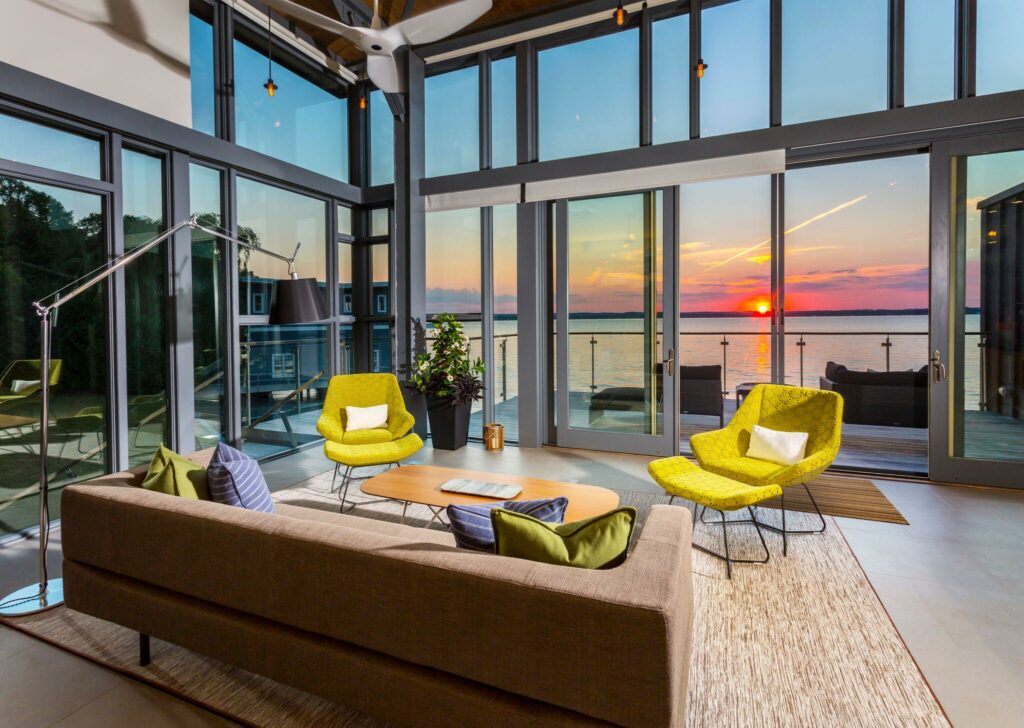 Sunset view from the interior of Malibu on Simcoe featuring expansive glass windows overlooking Lake Simcoe - Jayne's Luxury Rentals.