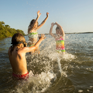 Children playing in lake waters during summer - Joyful moments at Jayne's Luxury Rentals