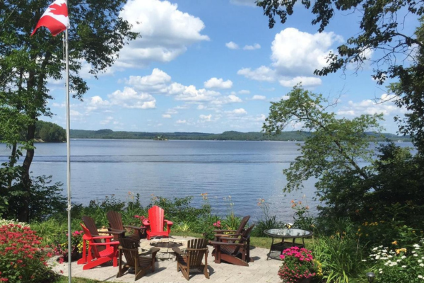 Scenic lakefront view with comfortable outdoor seating and a fire pit at Jayne's Luxurious Rentals
