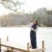 A couple in a romantic embrace on a serene lakeside dock at sunset, encapsulating the essence of a luxury couple's getaway.