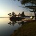Serene dawn at Laridae with calm waters and lush trees - Family-friendly island retreat - Jayne's Luxury Rentals