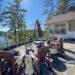 Serene dock view at The Rose with pink Adirondack chairs facing a misty lake - Jayne's Luxury Rentals.