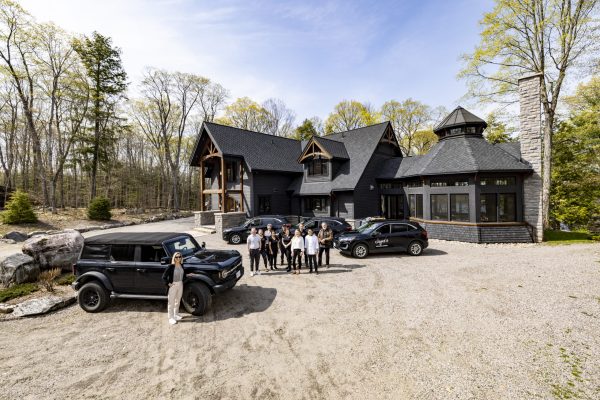 Jayne's Luxury Rentals' dedicated Concierge Team poised in front of a premium Muskoka property, ready to deliver exceptional service.